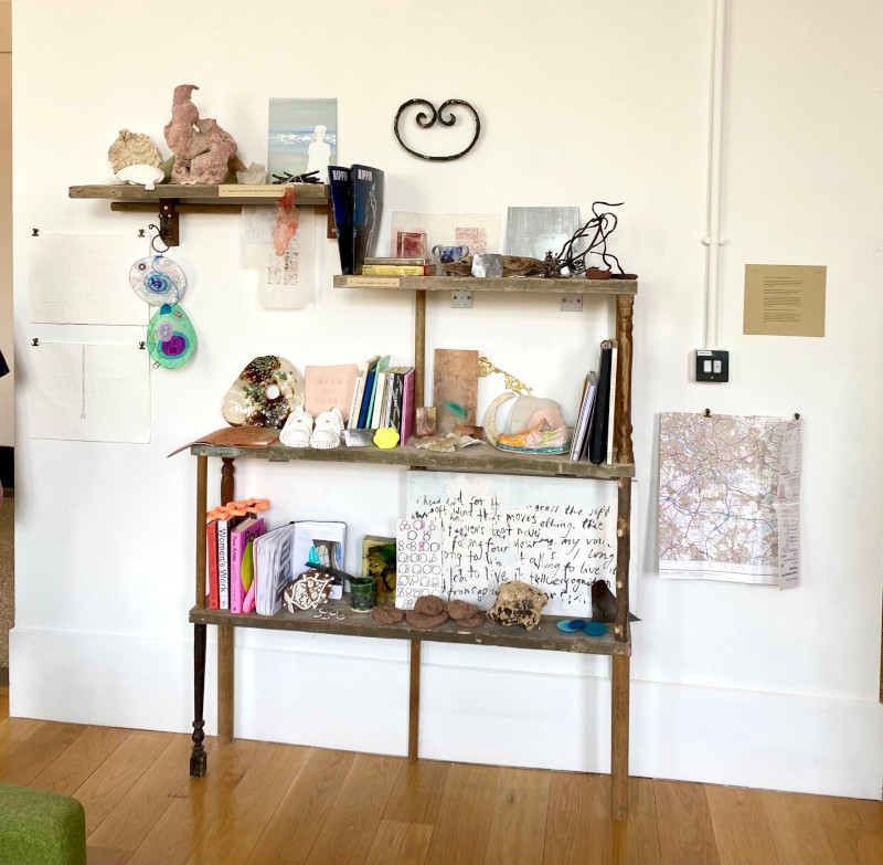 Archive constructed of recycled wood with objects on each shelf